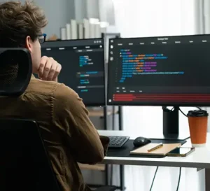 Developer coding an ASP.NET Zero web application on a computer