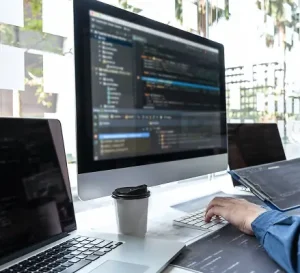 Software developer coding on computer screen using modern programming languages