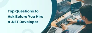 Developer working on multiple screens representing top questions to ask before hiring a .NET developer