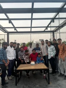 Office team celebrating Men’s Day with decorations, cake, and gifts for male employees