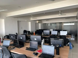 Modern office workspace with laptops and desktop computers in an IT company